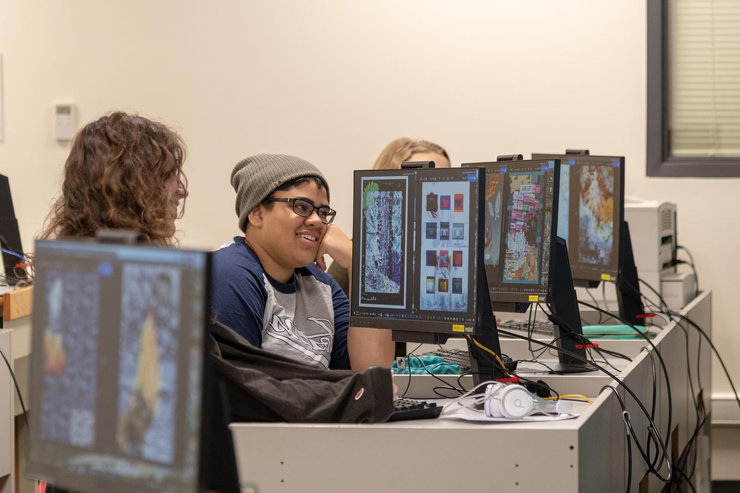 Foundations students critiquing artwork in computer lab. (Fall 2018)